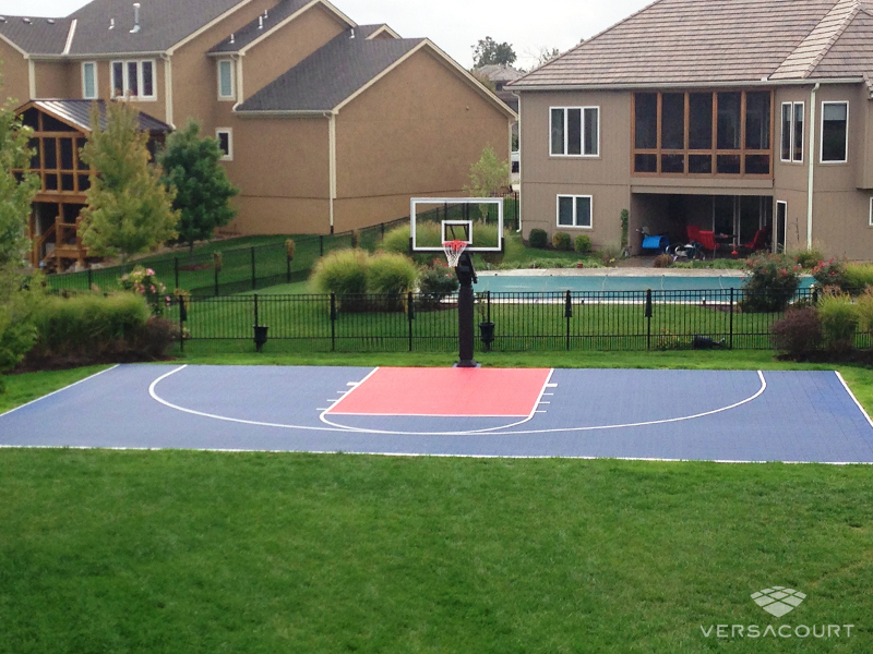 Blue and red VersaCourt half court beside a pool